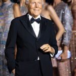 Giorgio Armani poses with models