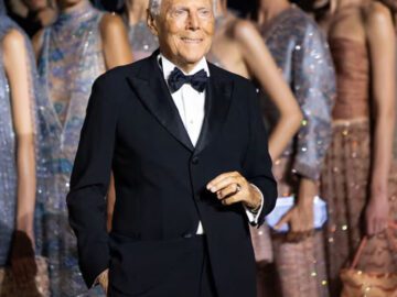 Giorgio Armani poses with models